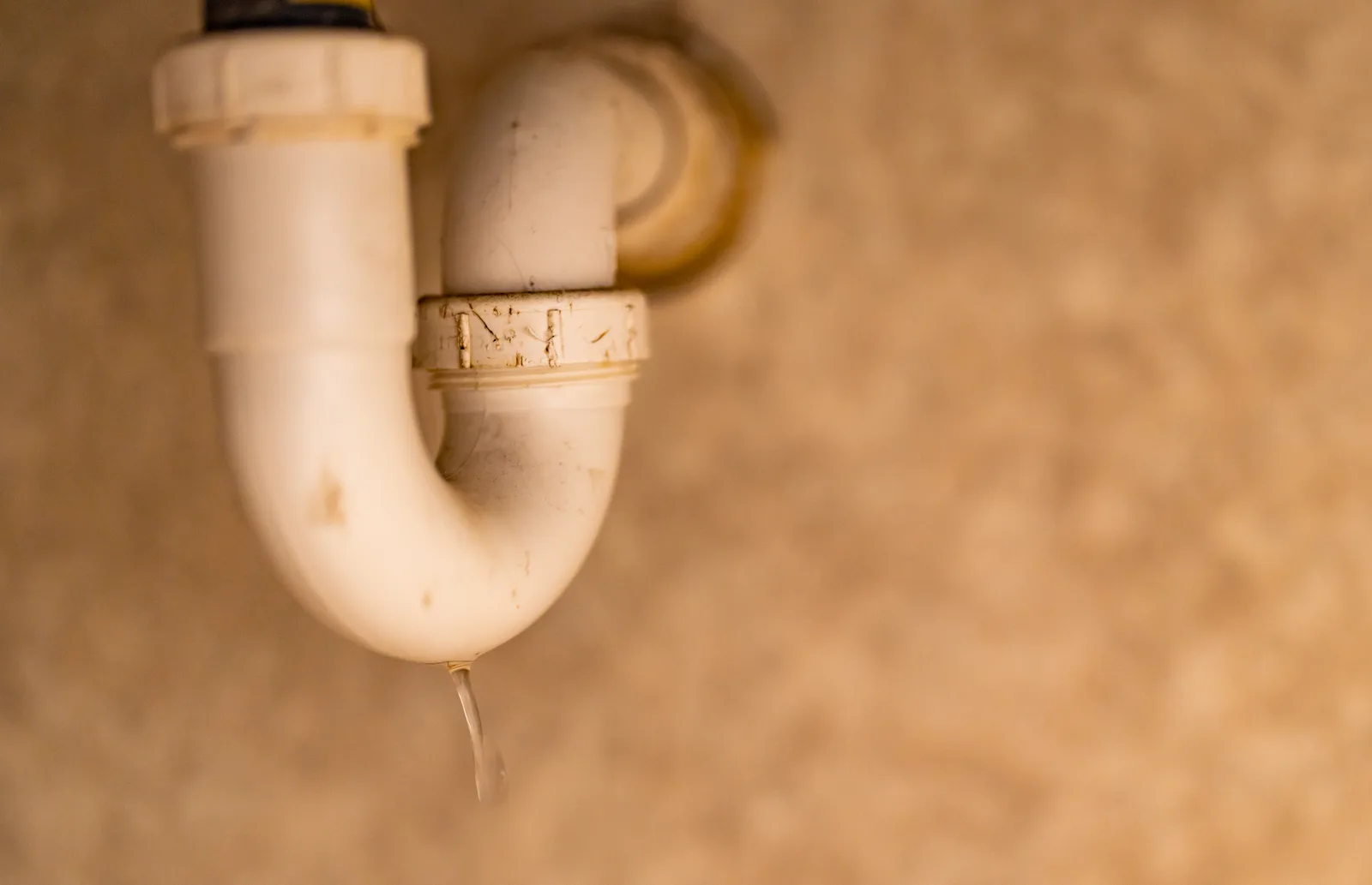 Leaking PVC drain pipe under a sink